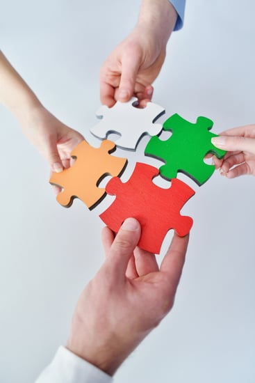 Group of business people assembling jigsaw puzzle and represent team support and help concept-1