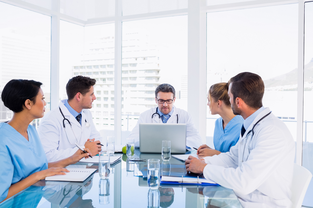 Concentrated medical team around desk in the office Concentrated medical team around desk in the office