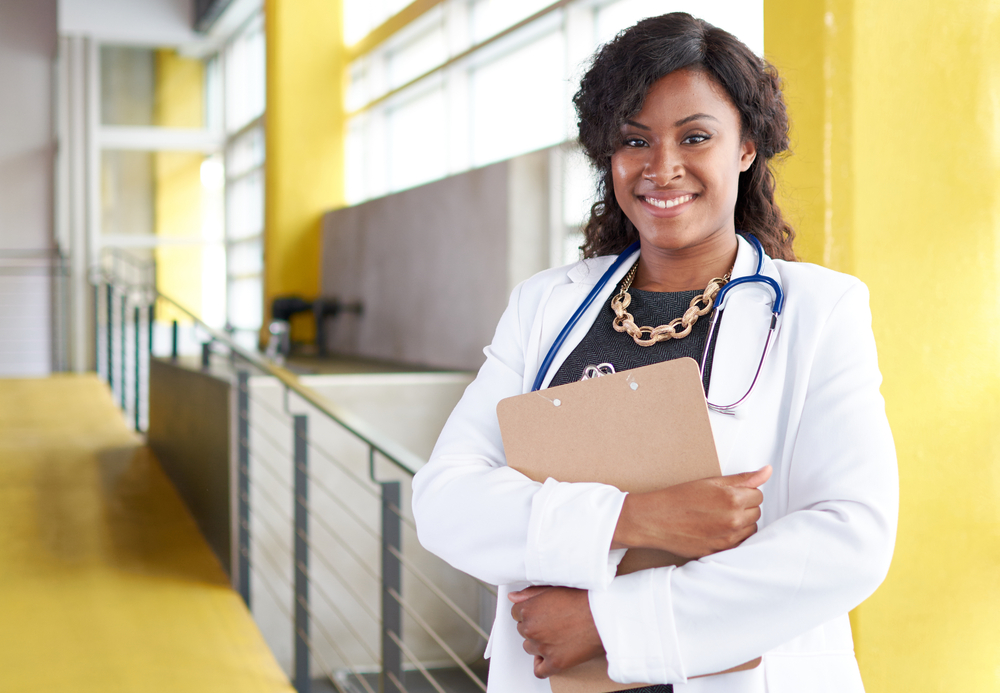 Portrait of a female doctor holding her patient chart in bright modern hospital Portrait of a female doctor holding her patient chart in bright modern hospital