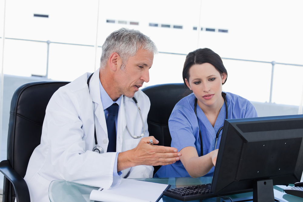 Professional medical team working with a computer in an office Professional medical team working with a computer in an office